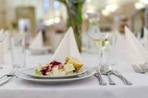 Interior of elegant restaurant with folded napkins and appetizer plate
